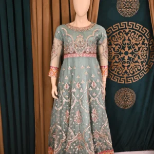 Elegant Organza Maxi with intricate heavy embroidery, paired with flapper trousers and a delicate net dupatta, perfect for traditional Pakistani and Indian wear, ideal for weddings and festive occasions.