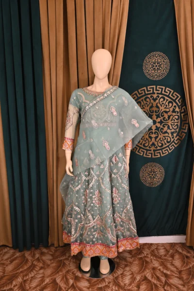 Elegant Organza Maxi with intricate heavy embroidery, paired with flapper trousers and a delicate net dupatta, perfect for traditional Pakistani and Indian wear, ideal for weddings and festive occasions.