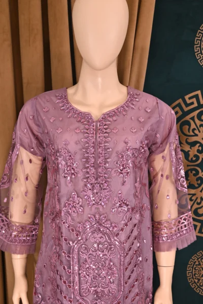 Handmade traditional wear featuring heavy floral embroidery on net and cambric fabric, showcasing elegant Pakistani and Indian design with intricate craftsmanship