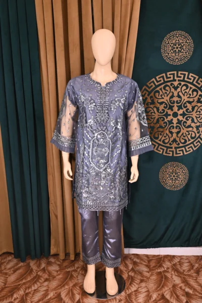 Handmade traditional wear featuring heavy floral embroidery on net and cambric fabric, showcasing elegant Pakistani and Indian design with intricate craftsmanship