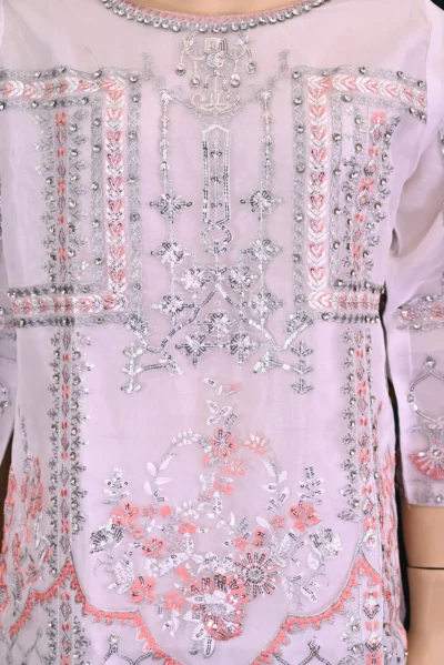 Elegant traditional wear featuring intricate floral embroidery on luxurious organza fabric. Handmade with rich craftsmanship, ideal for special occasions and cultural celebrations