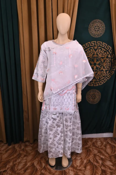 Elegant traditional wear featuring intricate floral embroidery on luxurious organza fabric. Handmade with rich craftsmanship, ideal for special occasions and cultural celebrations